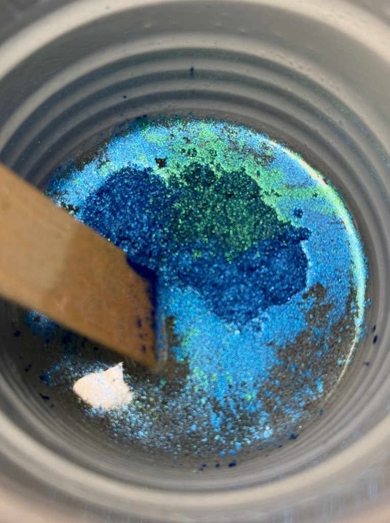 kiji blue pigment in a resin cup.